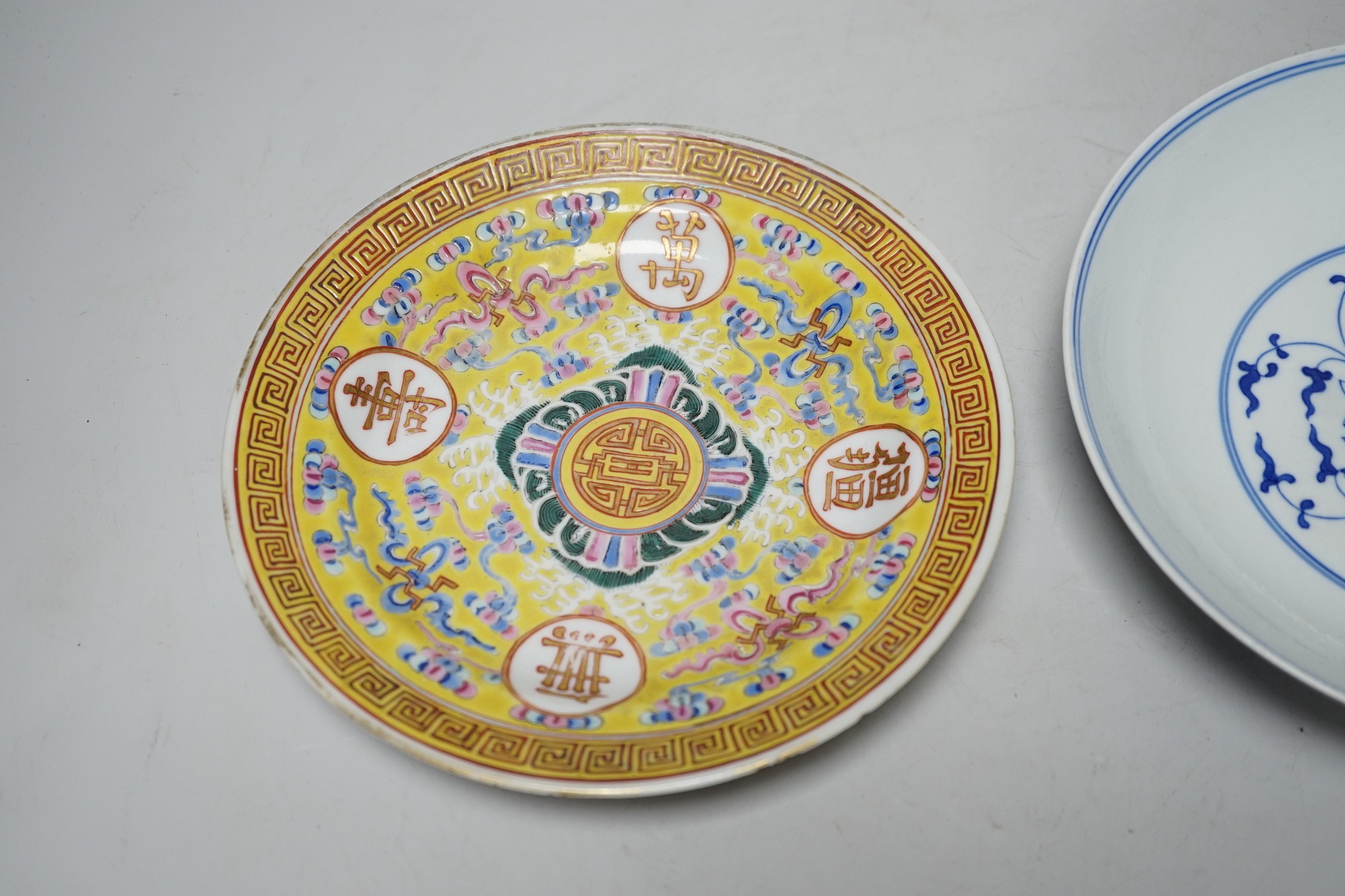 A Chinese blue and white dish and a similar enamelled dish, largest 20cm